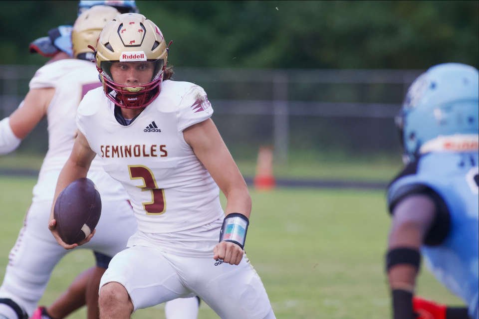 Florida High quarterback Jeremy Johnston (3) keeps the ball in a game between Florida High and Gadsden County on Sep.15, 2023, at Gadsden County High School. The Seminoles won, 45-22.