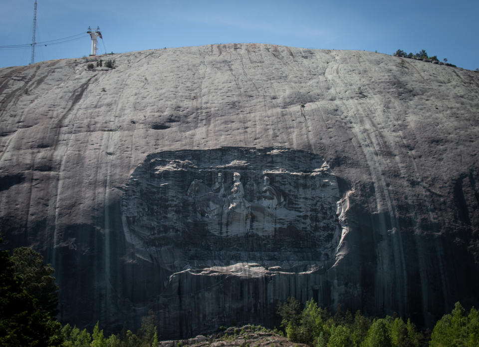 A massive mountainside carving depicting Confederate leaders Jefferson Davis, Robert E. Lee and Stonewall Jackson is shown on Monday, April 26, 2021, in Stone Mountain, Ga. The Stone Mountain Memorial Association, which oversees the park's design, is considering changes to the park's deeply contentious features honoring the Confederacy. (AP Photo/Ron Harris)