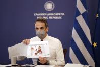 In this photo provided by the Greek Prime Minister's Office, Greece's Prime Minister Kyriakos Mitsotakis shows a map of Europe during his announcement on the country's new lockdown in Athens, Thursday, Nov. 5, 2020. Mitsotakis has announced a nationwide three-week lockdown starting Saturday morning, saying that the increase in the coronavirus infections must be stopped before Greece's health care system comes under "unbearable" pressure. (Dimitris Papamitsos/Greek Prime Minister's Office via AP)