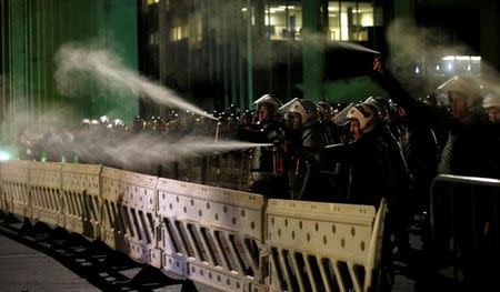 Police officers use pepper spray on demonstrators against the impeachment of President Dilma Rousseff in Brasilia, Brazil, May 11, 2016. REUTERS/Paulo Whitaker