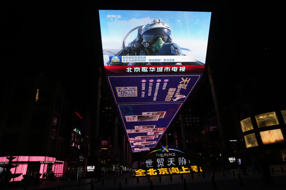 FILE - An outdoor screen depicts a Chinese fighter jet pilot giving a thumbs up in the recently concluded Joint Sword exercise around Taiwan during the evening news broadcast in Beijing, on April 10, 2023. In the weeks since Chinese leader Xi Jinping won a third five-year term as president, setting him on course to remain in power for life, leaders and top diplomats from around the world have been beating a path to his door. None more-so than those from Europe. (AP Photo/Ng Han Guan, File)