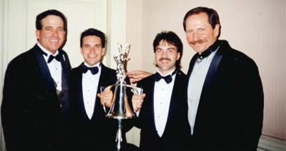 From left to right: Ron Hornaday Jr., Kevin Cram, Clinton Cram and Dale Earnhardt Sr. pose for a photo during a 1996 banquet. (Photo courtesy of Kevin Cram)