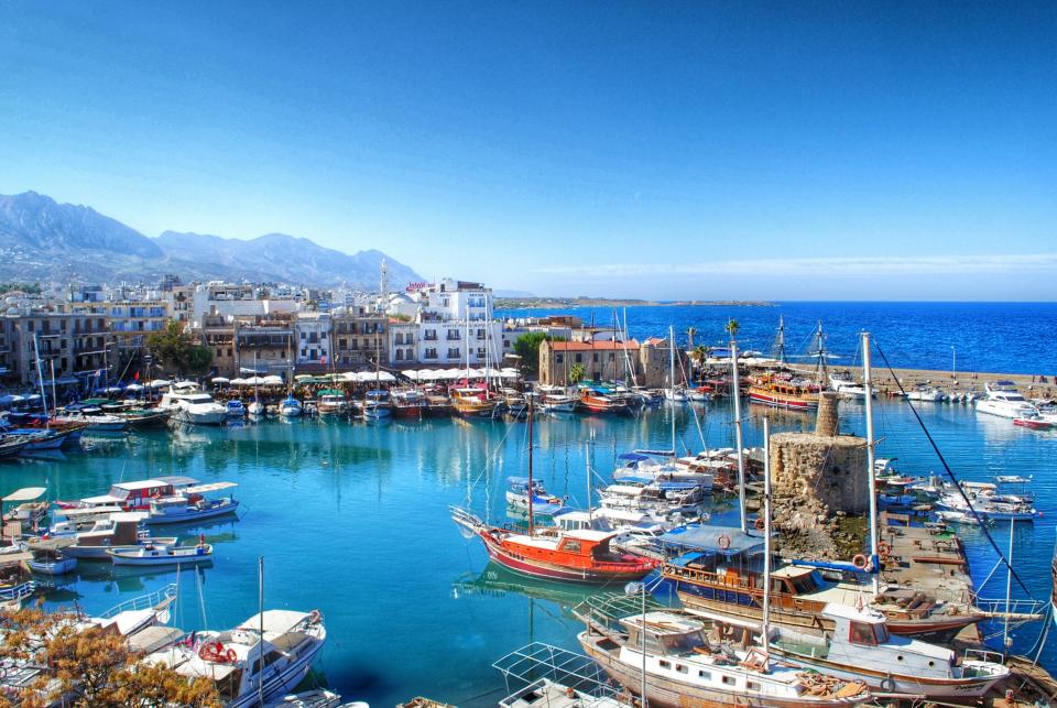 High Angle View Of Boats Moored At Harbor Against Clear Blue Sky