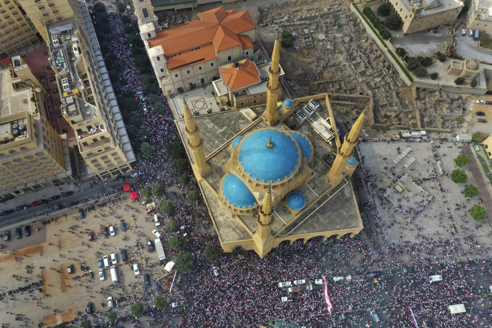 FILE - In this Sunday, Oct. 20, 2019 file photo, an aerial view shows anti-government protest, in downtown Beirut, Lebanon. A year ago, hundreds of thousands of Lebanese took to the streets in protests nationwide that raised hopes among many for a change in a political elite that over that decades has run the country into the ground. (AP Photo/Hussein Malla, File)