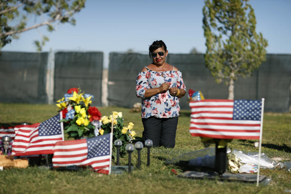 Angelica Cervantes kneels at her son Erick Silva's grave Saturday, Sept. 29, 2018, in Las Vegas. Silva was one of 58 people killed Oct. 1, 2017, in the deadliest mass shooting in modern U.S. history. Silva was working as a security guard at the Route 91 Harvest Festival and was shot while helping people climb over a barricade to escape the gunfire. (AP Photo/John Locher)