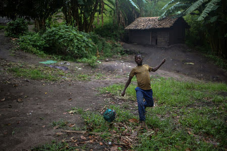 A boy plays football, at Kagorwa Pygmy camp on Idjwi island in the Democratic Republic of Congo, November 22, 2016. REUTERS/Therese Di Campo