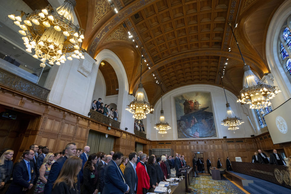 FILE - All rise as judges, rear, enter the World Court where Ukraine's legal battle against Russia over allegations of genocide used by Moscow to justify its 2022 invasion, resumed in The Hague, Netherlands, Monday, Sept. 18, 2023. South Africa has launched a case at the United Nations' top court alleging that Israel's military campaign in Gaza amounts to genocide. The filing and Israel's decision to defend itself at the International Court of Justice sets up a high-stakes showdown in the before a bench of the court's black-robed judges in the wood-panelled Great Hall of Justice. (AP Photo/Peter Dejong, File)