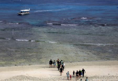 Tourists prepare to board a boat to snorkel in an area called the 'Coral Gardens' located at Lady Elliot Island, north-east of the town of Bundaberg in Queensland, Australia, June 10, 2015. REUTERS/David Gray