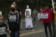 Sister Quincy Howard, center, a Dominican nun, protests the arrival of President Donald Trump to the Saint John Paul II National Shrine, Tuesday, June 2, 2020, in Washington. Many demonstrators present said they were dismayed when Trump staged a visit to the historic St. John's Church across from the White House and held up a Bible after authorities had cleared the area of peaceful protesters. "I'm here in protest," says Howard, "of violence, of inciting violence, of systemic racism and using religion as a shield." Protests continue over the death of George Floyd, who died after being restrained by Minneapolis police officers. (AP Photo/Jacquelyn Martin)