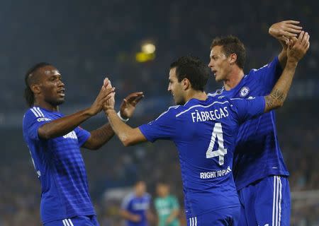 Chelsea's Cesc Fabregas (C) celebrates with team mates Didier Drogba (L) and Nemanja Matic after scoring a goal against Schalke 04 during their Champions League soccer match against at Stamford Bridge in London September 17, 2014. REUTERS/Eddie Keogh