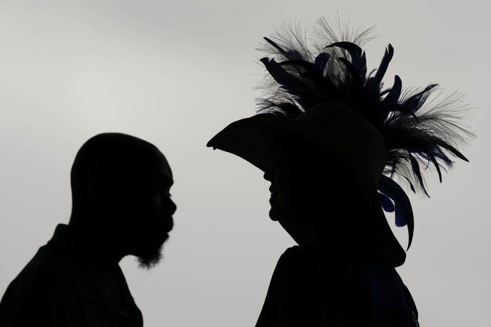 Race fans walk though the stands Churchill Downs before the 150th running of the Kentucky Derby horse race Saturday, May 4, 2024, in Louisville, Ky. (AP Photo/Charlie Riedel)