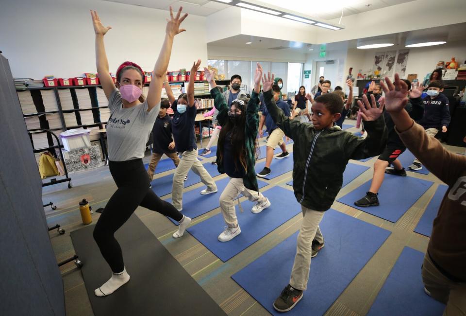 Leah Rose Gallegos co-founder of People's Yoga, leads a class of fifth-graders.