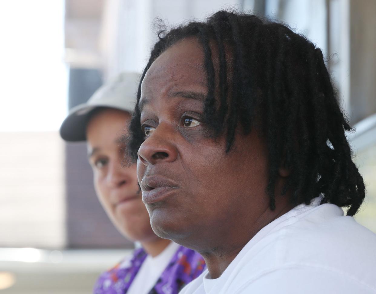 LaToya Synder listens as her mom Tracy Snyder talks about her grandson and LaToya's nephew 17-year-old Antenio "Teno" Louis. Louis was shot dead in Akron while catching a ride to football practice.