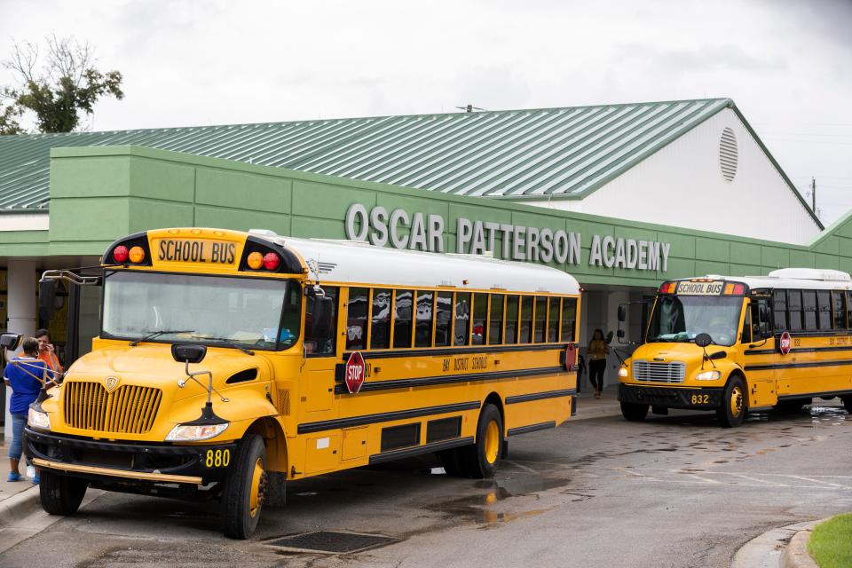 Buses line up in front of Oscar Patterson Academy after the first day of classes on Wednesday.