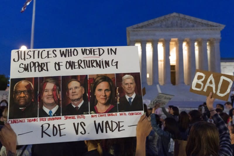 2022年5月3日，墮胎支持者在聯邦最高法院外高舉五位「戰犯」的照片：他們分別是保守派大法官湯瑪斯、卡瓦諾、阿利托、巴雷特和葛薩奇（由左至右）。（美聯社）
