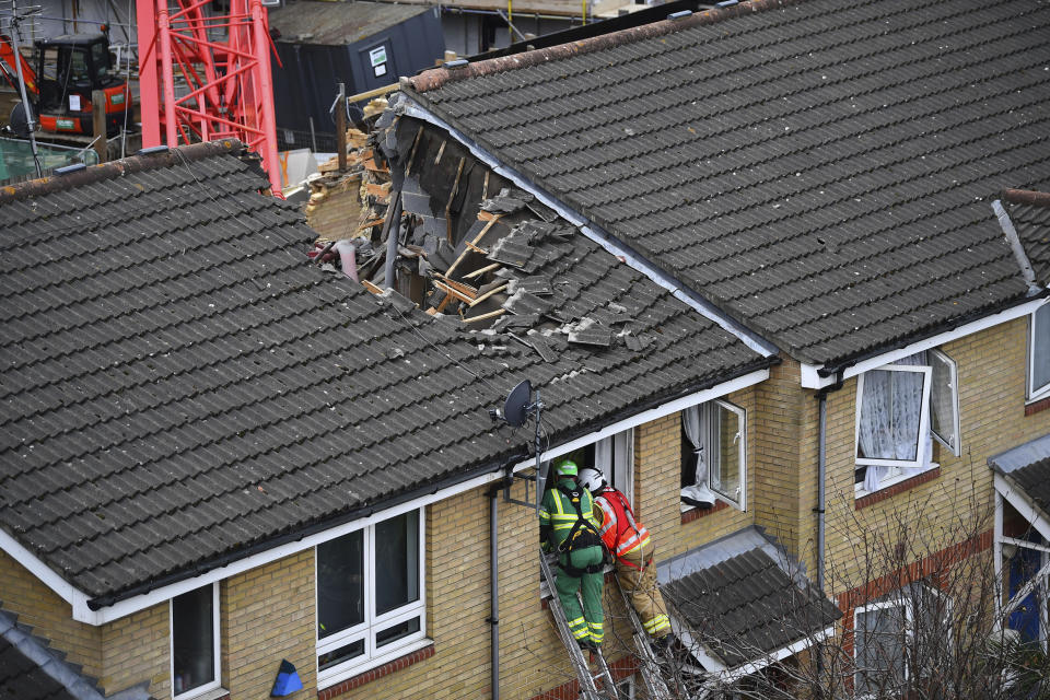 Emergency personnel at the scene in Bow where a 20-metre crane collapsed on to a property leaving people trapped inside, in east London, Wednesday July 8, 2020. The London Fire Brigade says a 20-meter crane has collapsed onto a block of apartments under development and two houses in east London. The brigade’s Assistant Commissioner Graham Ellis says urban search and rescue crews are undertaking “a complex rescue operation” and using specialized equipment to search the properties on Wednesday. (Victoria Jones/PA via AP)