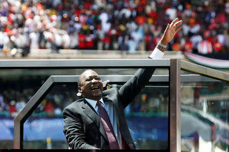 FILE PHOTO: Kenya's President Uhuru Kenyatta waves upon his arrival to his inauguration ceremony where he will be sworn in as president at Kasarani Stadium in Nairobi, Kenya November 28, 2017. REUTERS/Baz Ratner/Files