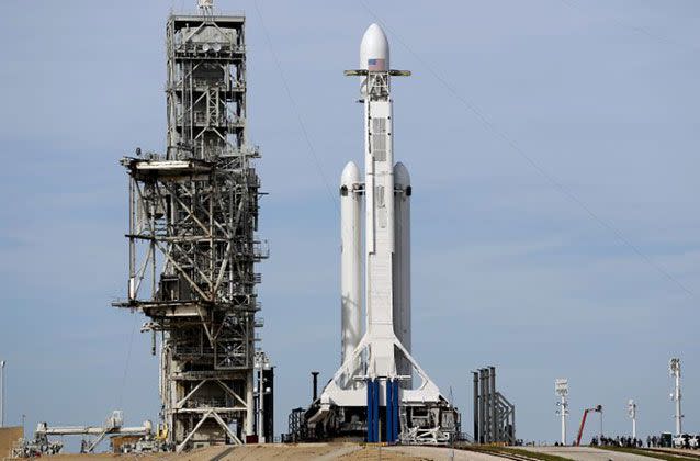 SpaceX’s big new rocket blasted off Tuesday on its first test flight, carrying a red sports car aiming for an endless road trip past Mars. Source: AP