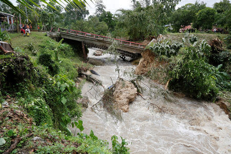 A bridge that collapsed after heavy rains brought by Hurricane Earl is seen at Menchor de Mencos, Guatemala. REUTERS/Luis Echeverria