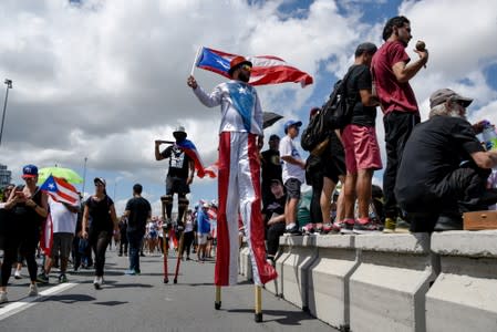 Demonstrators in costumes attend the national strike calling for the resignation of Governor Ricardo Rossello, in San Juan