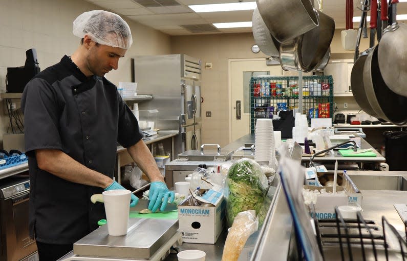 man cutting vegetables at NIH kitchen