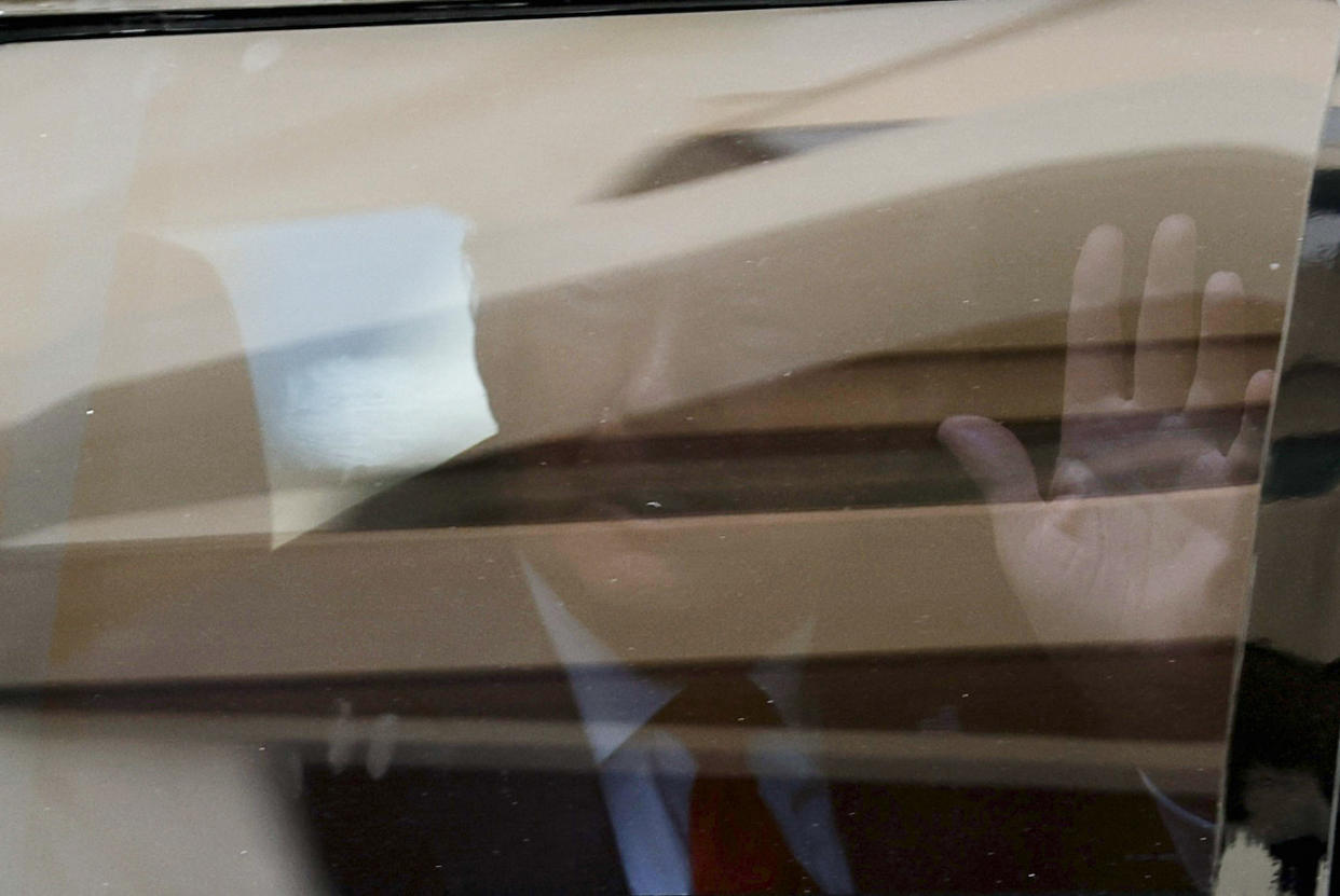 Trump waves from his car after his arraignment on the classified document charges.