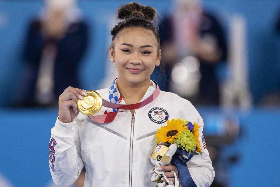 <p>Tim Clayton/Corbis via Getty</p> Suni Lee on the podium with her gold medal after winning the All-Around Final for Women on July 29, 2021 during the Tokyo Summer Olympics.