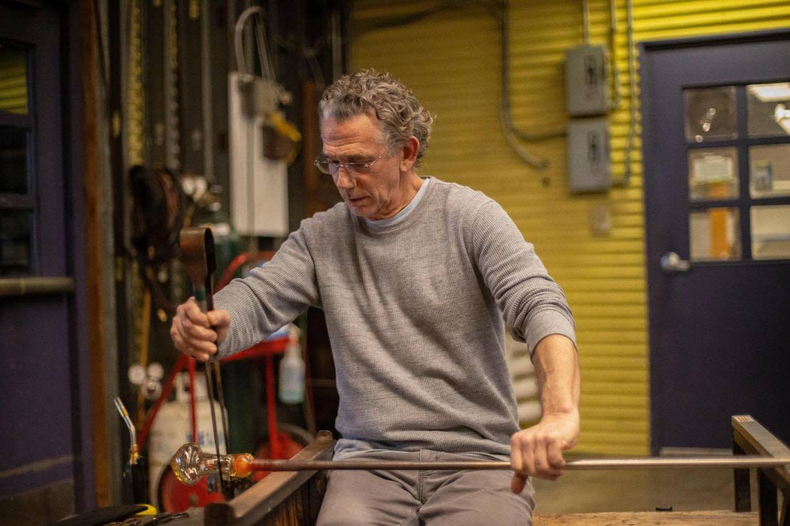 Patrick Martin, Centre College professor of art, demonstrates how to work with hot glass at the glassblowing studio in the Jones Visual Arts Center at Centre College in Danville, Ky., on Monday, Nov. 28, 2022. Martin studied under Stephen Rolfe Powell when Martin was a student at Centre.