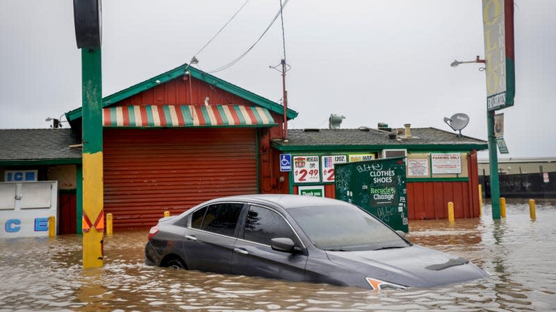 Photo of submerged car and building