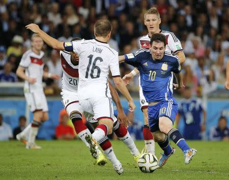 Argentina's Lionel Messi is challenged by Germany's Jerome Boateng and Philipp Lahm during their 2014 World Cup final at the Maracana stadium in Rio de Janeiro July 13, 2014. REUTERS/Sergio Moraes