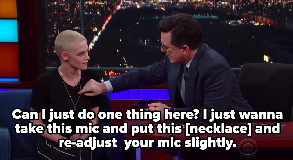 Stephen Colbert adjusting Kristen Stewart's microphone