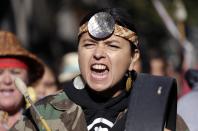 <p>A Native American woman drums and sings as she marches during an Indigenous Peoples Day event Monday, Oct. 9, 2017, in Seattle, Wash. (Photo: Elaine Thompson/AP) </p>