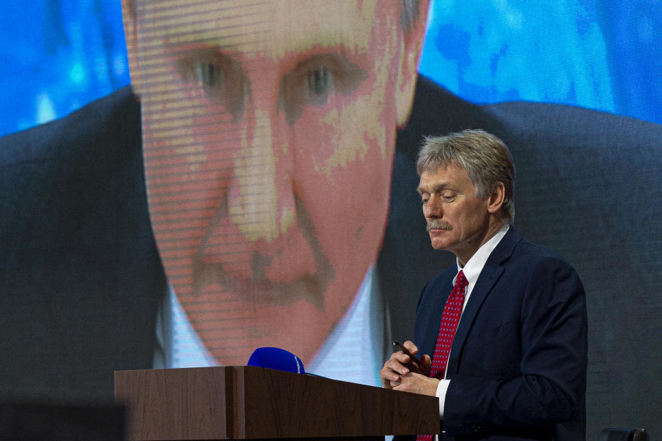 FILE - In this Dec. 17, 2020, file photo, Kremlin spokesman Dmitry Peskov looks on as Russian President Vladimir Putin speaks via video call during a news conference in Moscow, Russia. Rattled by nationwide protests over jailed opposition leader Alexei Navalny, Russian authorities are moving rapidly to block any new ones – from piling legal pressure on his allies, to launching a campaign to discredit the demonstrations. Peskov said a “negligible number” of people turned out to the rallies, compared with the number of people who vote for Putin. (AP Photo/Alexander Zemlianichenko, File)