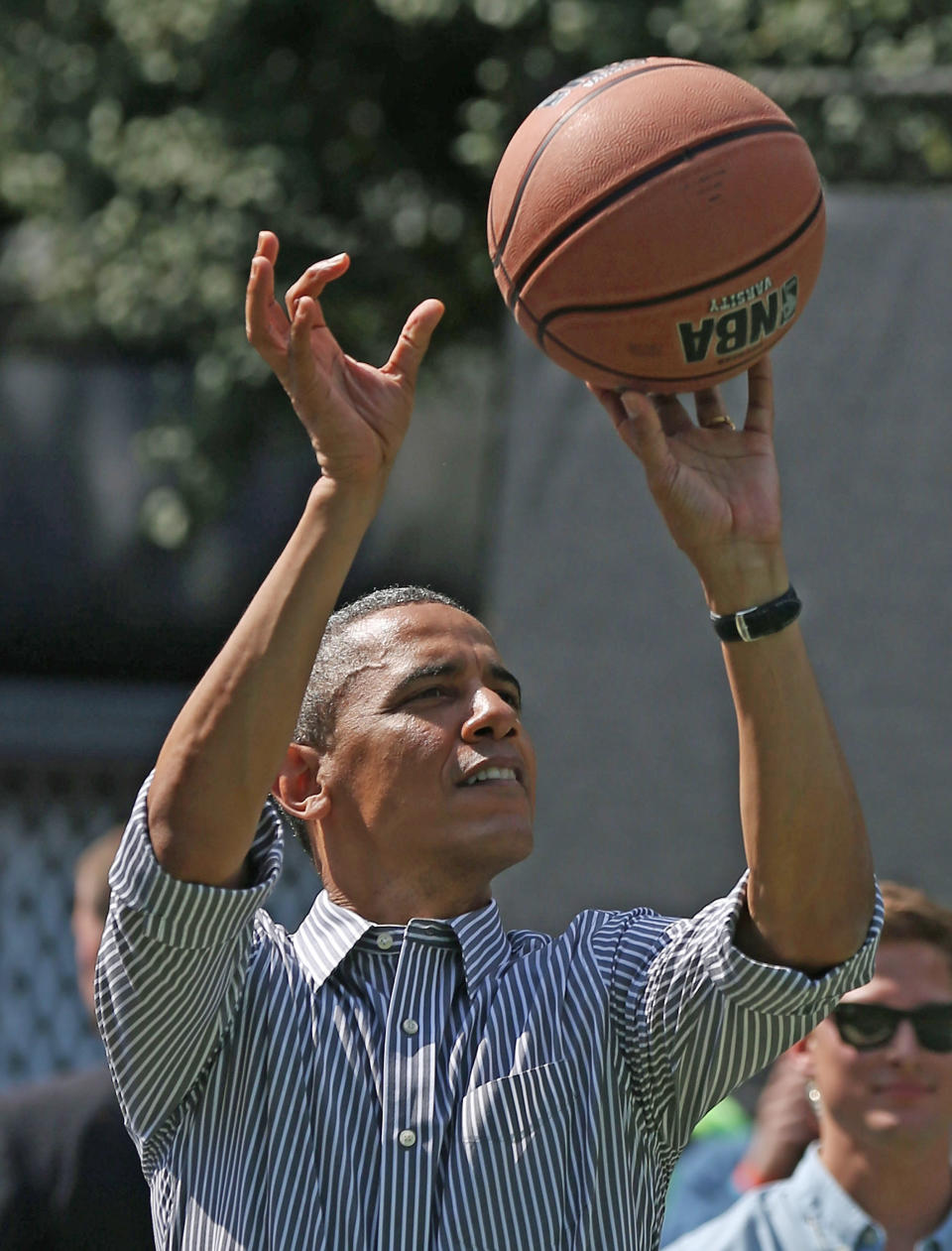 U.S. President Barack Obama plays basketball during the annual Easter Egg Roll on the White House tennis court April 1, 2013 in Washington, DC. Thousands of people are expected to attend the 134-year-old tradition of rolling colored eggs down the White House lawn that was started by President Rutherford B. Hayes in 1878.