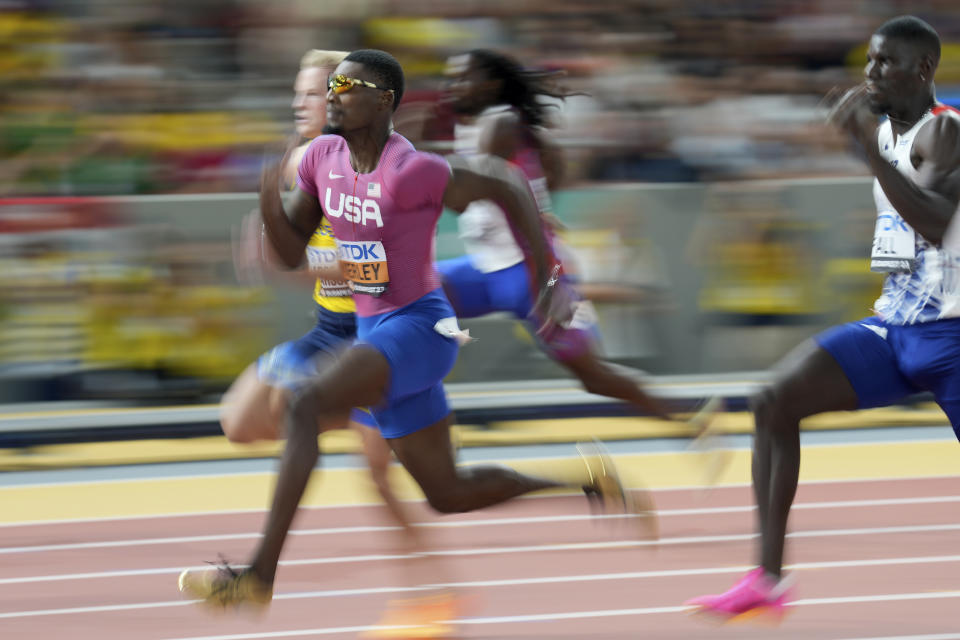 Fred Kerley, of the United States, runs ahead of Henrik Larsson, of Sweden, left, in a Men's 100-meter heat during the World Athletics Championships in Budapest, Hungary, Saturday, Aug. 19, 2023. (AP Photo/Matthias Schrader)