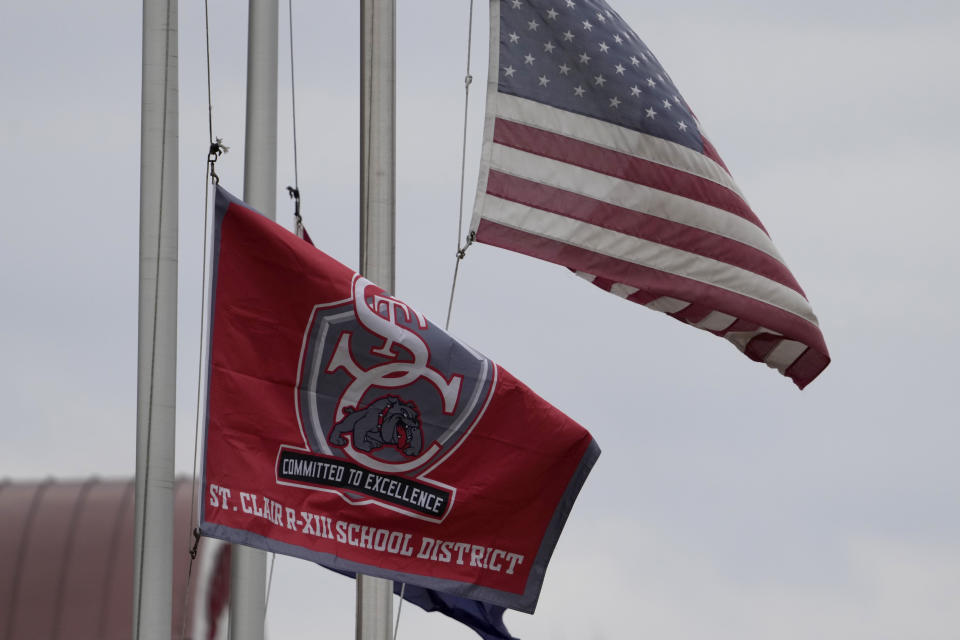 A St. Clair School District flag flies outside an elementary school, Friday, Dec. 8, 2023, in St. Clair, Mo. Two teachers at the district's rural Missouri high school have resigned after it was discovered they were posting racy content on the subscription platform OnlyFans. (AP Photo/Jeff Roberson)