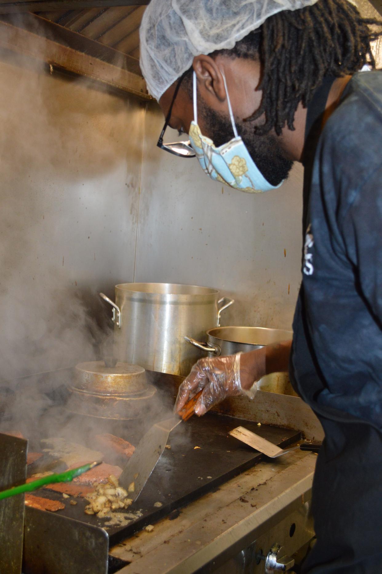 Brandon Hawthorne, co-owner of Twisted Plants, prepares a vegan burger at the Cudahy restaurant. It's among numerous places to get vegan fare throughout the suburbs.