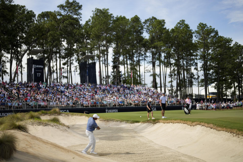 Tiger Woods hits from the bunker on the 17th hole during a practice round for the U.S. Open golf tournament Monday, June 10, 2024, in Pinehurst, N.C. (AP Photo/Matt York)