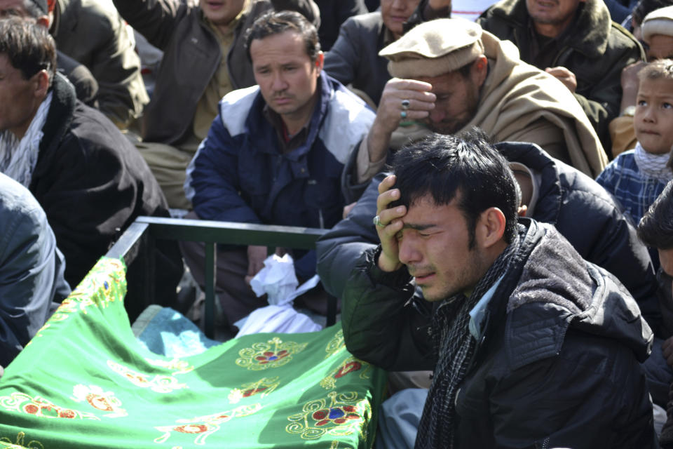 A Pakistani man, grieves next to the body of a relative, who was killed on Tuesday by a bomb blast, during a protest in Quetta, Pakistan, Wednesday, Jan. 22, 2014. Shiite Muslims in Baluchistan protested Wednesday in Quetta, the capital of Baluchistan, demanding action to stop the continued violence against their sect; they brought the coffins of many of the dead into the streets as part of their protest. (AP Photo/Arshad Butt)