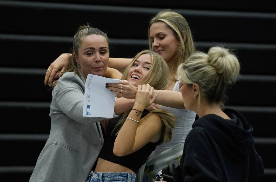 Faith Bryant (back) and Abbie Hollis (front) are hugged at Archbishop Blanch School in Liverpool, as students receive their A-Level results. Picture date: Tuesday August 10, 2021. (Photo by Peter Byrne/PA Images via Getty Images)