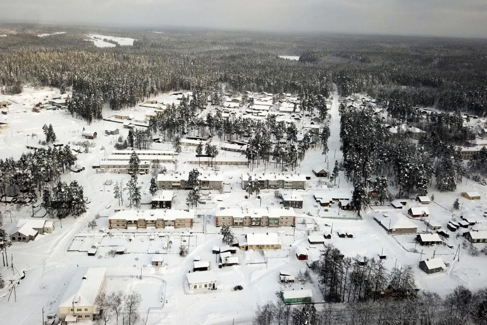 Snow coats the village of Ikhala in Russia’s Karelia region, Tuesday, Feb. 16, 2021. The village of wooden houses — carved out of a dense forest of fir trees near the Finnish border and north of St. Petersburg — is one of several in the Karelia region where Russia’s slow rollout of its vaccination campaign has arrived at last. (AP Photo/Kirill Zarubin)