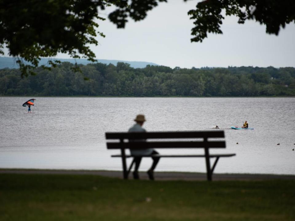 Paddlers and kite surfers are seen at Britannia Beach in Ottawa on Sunday, July 24, 2022. (Spencer Colby/The Canadian Press - image credit)