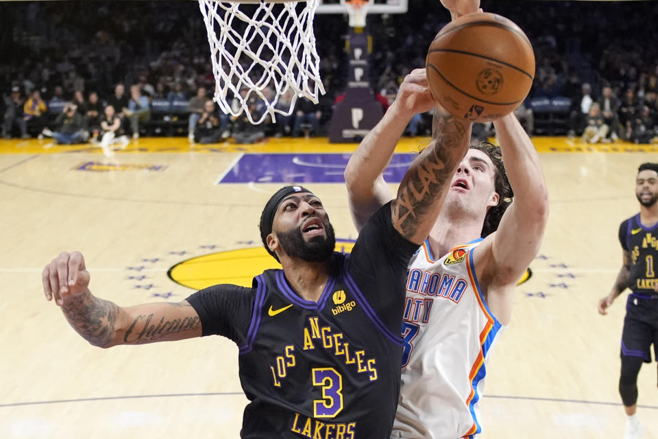 Los Angeles Lakers forward Anthony Davis, left, and Oklahoma City Thunder guard Josh Giddey go after a rebound during the first half of an NBA basketball game Monday, Jan. 15, 2024, in Los Angeles. (AP Photo/Mark J. Terrill)