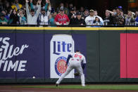 Fans cheer as Atlanta Braves left fielder Jarred Kelenic can't catch the RBI double hit by Seattle Mariners' Dylan Moore during the fourth inning of a baseball game Tuesday, April 30, 2024, in Seattle. (AP Photo/Lindsey Wasson)