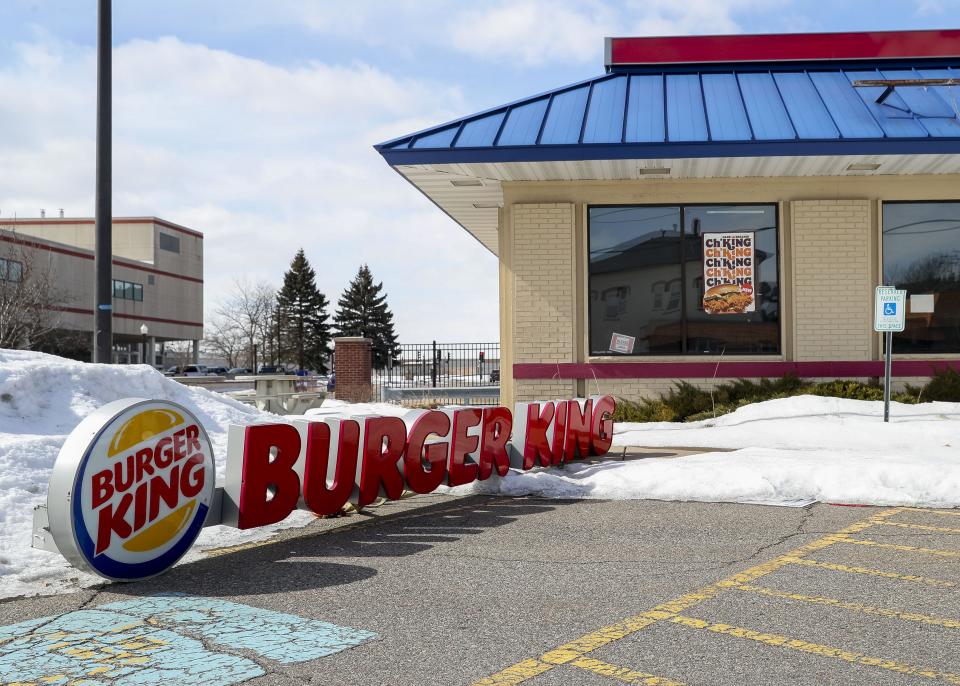 A roof sign is seen lying in the parking lot on Thursday at a permanently closed Burger King on North Sixth Street in Wausau.