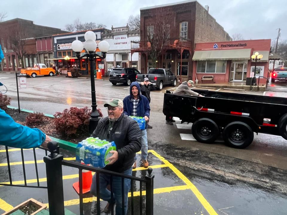 Volunteers from Troy Elmore Realty and Auction, located in Athens, Alabama, donate hundreds of cases of water to Lynnville residents, many of which were without water for more than two weeks due to recent winter weather.