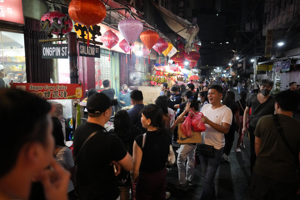 People line up for food at Binondo district, said to be the oldest Chinatown in the world, in Manila, Philippines on Tuesday, Feb. 6, 2024 Crowds are flocking to Manila's Chinatown to usher in the Year of the Wood Dragon and experience lively traditional dances on lantern-lit streets with food, lucky charms and prayers for good fortune. (AP Photo/Aaron Favila)