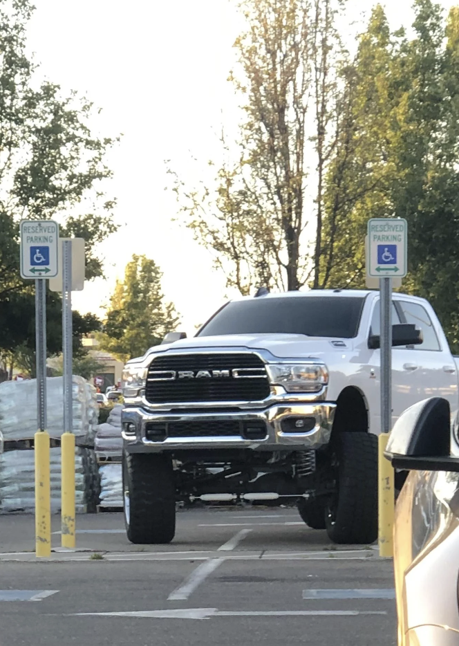 large lifted truck parking in the accessible parking