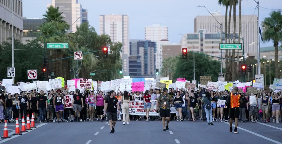 Thousands of protesters march around the Arizona Capitol after the Supreme Court decision to overturn the landmark Roe v. Wade abortion decision Friday, June 24, 2022, in Phoenix. The Supreme Court on Friday stripped away women’s constitutional protections for abortion, a fundamental and deeply personal change for Americans' lives after nearly a half-century under Roe v. Wade. The court’s overturning of the landmark court ruling is likely to lead to abortion bans in roughly half the states. (AP Photo/Ross D. Franklin)