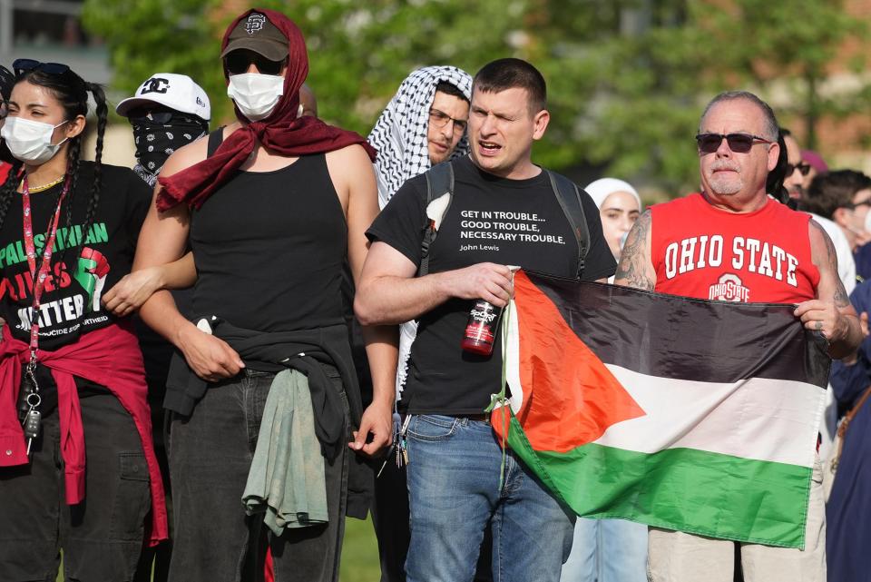 People lock arms during a protest at Ohio State University as demands are made for the university to divest from Israel over the Israel-Hamas war.